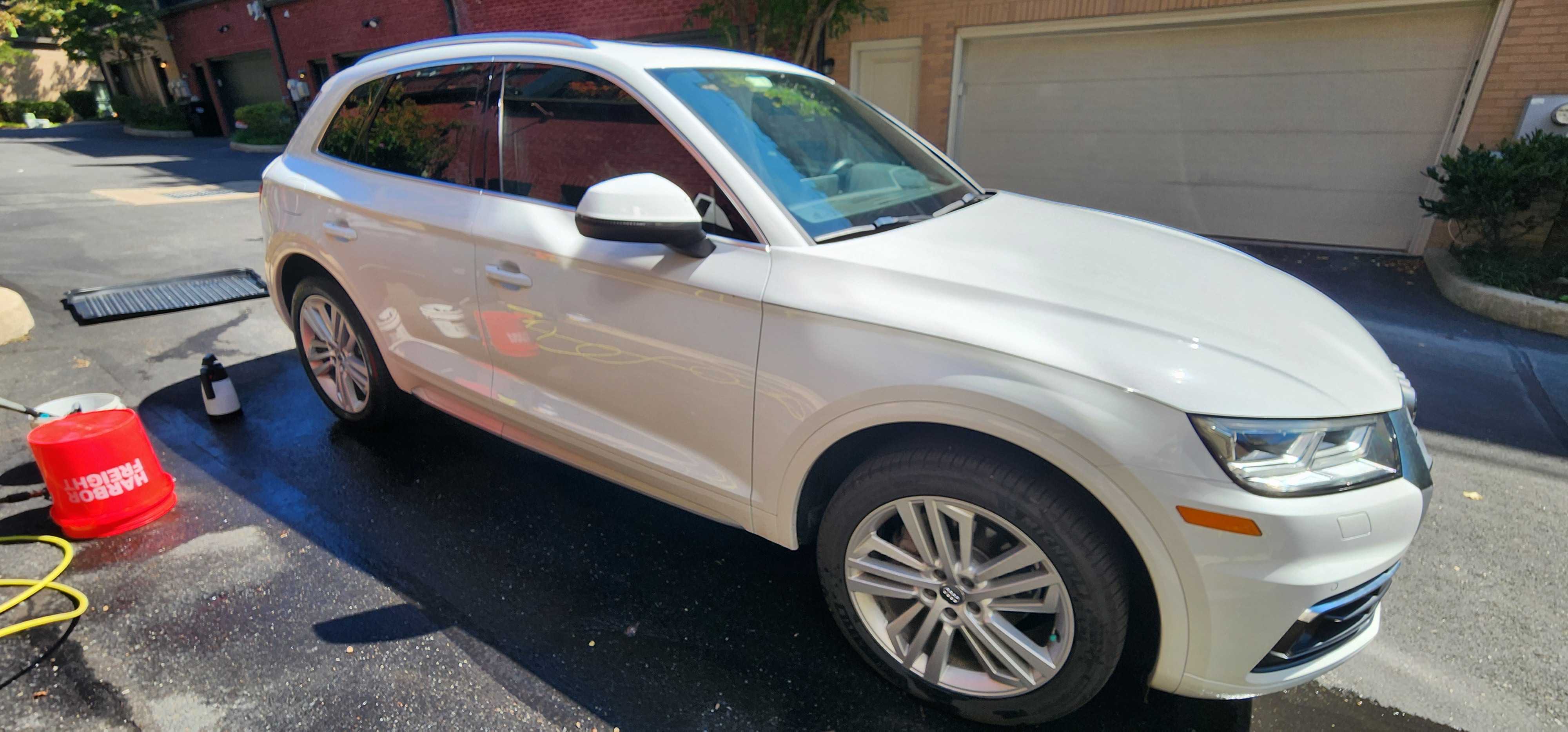Professional car detailing work - gleaming white vehicle